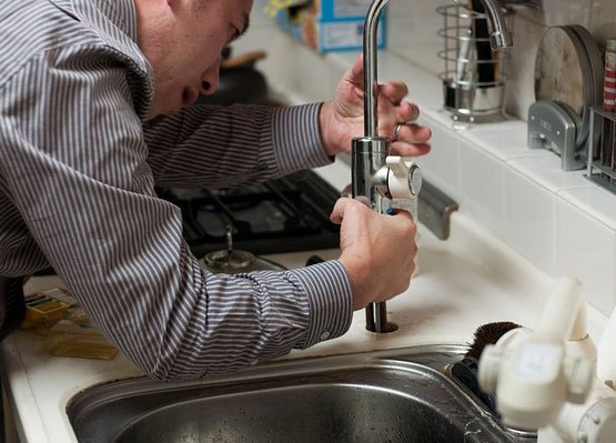 Plumber putting a kitchen sink together