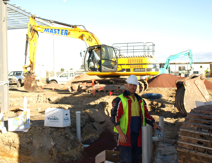 Backhoe digging for plumbing pipes 
